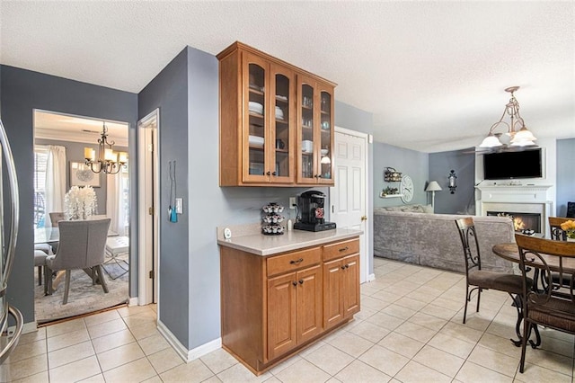 10 Callaway Ct, Hiram, GA 30141 - kitchen featuring an inviting chandelier, light tile patterned floors, brown cabinets, and light countertops