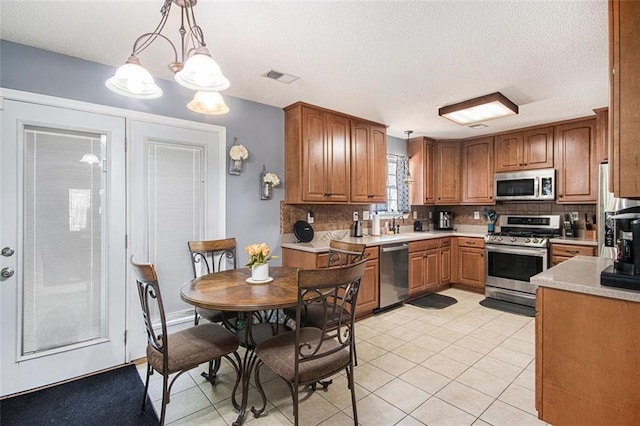 10 Callaway Ct, Hiram, GA 30141 - kitchen with visible vents, light countertops, backsplash, light tile patterned floors, and stainless steel appliances