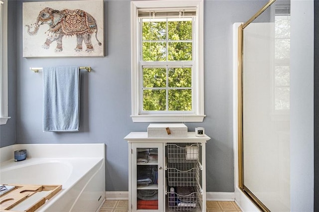 10 Callaway Ct, Hiram, GA 30141 - bathroom featuring a garden tub, baseboards, and a shower stall