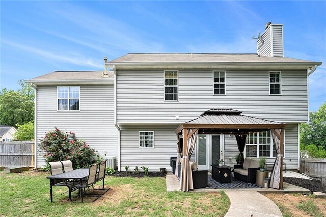 10 Callaway Ct, Hiram, GA 30141 - rear view of house featuring an outdoor living space, a chimney, a patio area, a gazebo, and fence