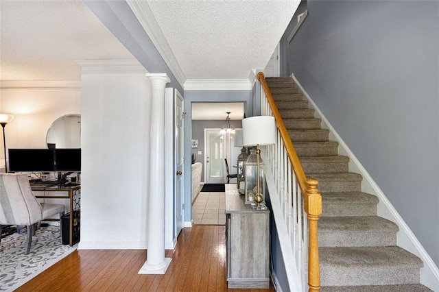 10 Callaway Ct, Hiram, GA 30141 - stairs with decorative columns, a textured ceiling, baseboards, ornamental molding, and hardwood / wood-style floors