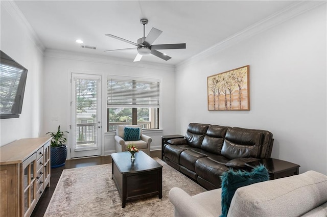 living room featuring ornamental molding, dark hardwood / wood-style flooring, and ceiling fan