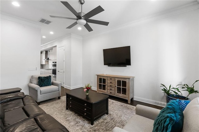 living room featuring ornamental molding, light wood-type flooring, and ceiling fan