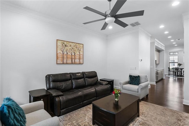 living room featuring ceiling fan, ornamental molding, and dark hardwood / wood-style flooring