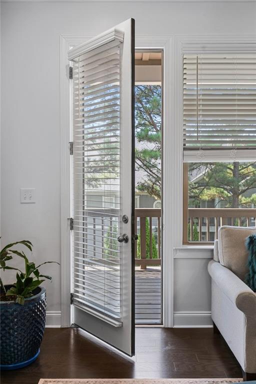 doorway to outside featuring dark hardwood / wood-style flooring and a wealth of natural light