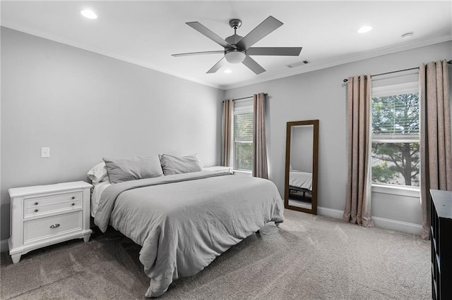 carpeted bedroom featuring ornamental molding, ceiling fan, and multiple windows