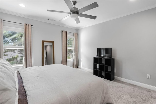 carpeted bedroom with ceiling fan and ornamental molding