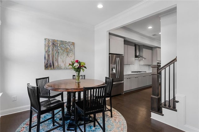 dining area featuring ornamental molding and dark hardwood / wood-style flooring