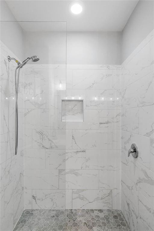 bathroom with a tile shower