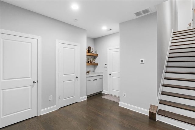 bar featuring dark wood-type flooring