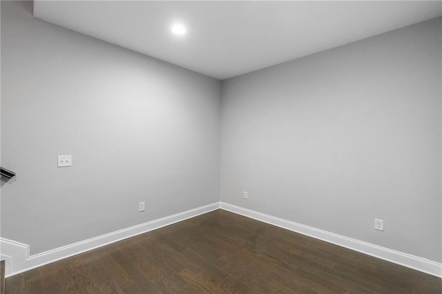 unfurnished room with dark hardwood / wood-style floors