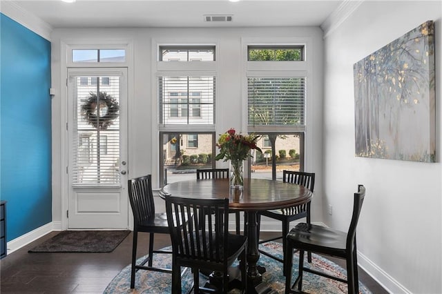 dining area featuring dark hardwood / wood-style floors, ornamental molding, and a wealth of natural light