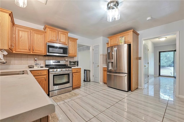 151 River Park Cir, Mcdonough, GA 30252 - kitchen with stainless steel appliances, light countertops, backsplash, a sink, and baseboards