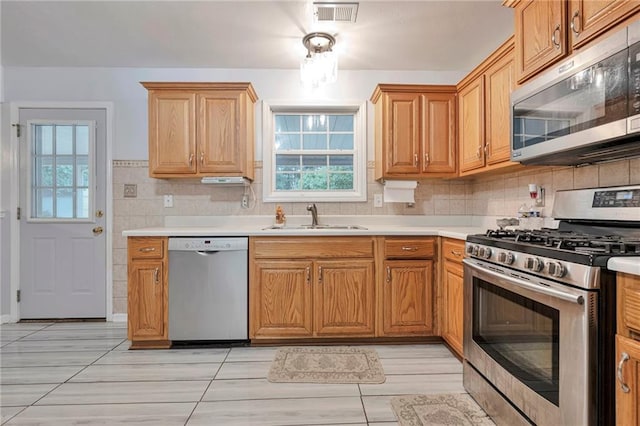 151 River Park Cir, Mcdonough, GA 30252 - kitchen with appliances with stainless steel finishes, a sink, light countertops, and backsplash