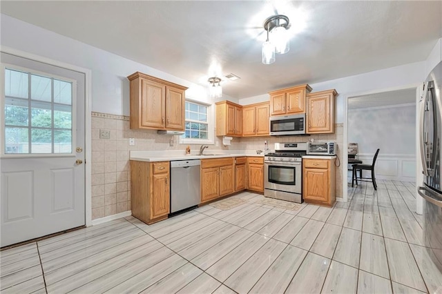 151 River Park Cir, Mcdonough, GA 30252 - kitchen with appliances with stainless steel finishes, light countertops, a sink, and a wainscoted wall