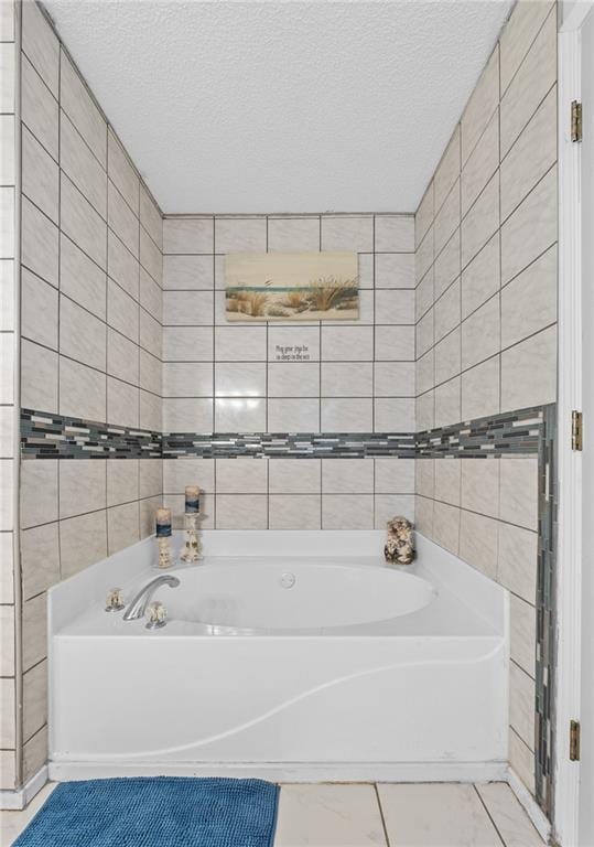 151 River Park Cir, Mcdonough, GA 30252 - bathroom featuring a bath, a textured ceiling, tile walls, and tile patterned floors