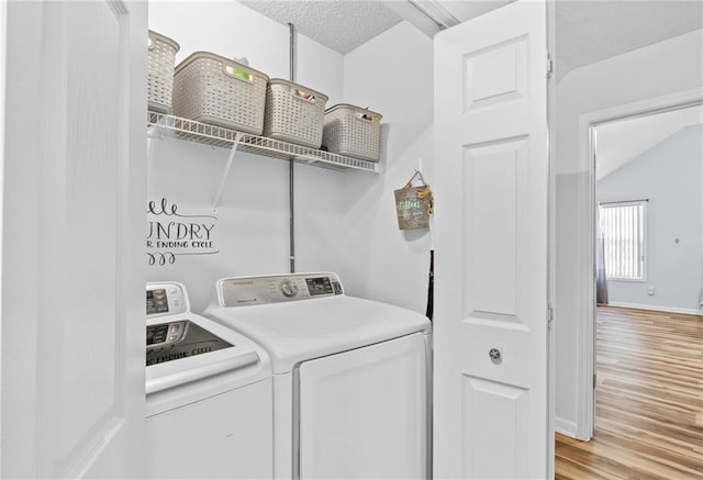 151 River Park Cir, Mcdonough, GA 30252 - laundry area with separate washer and dryer, light wood-style floors, baseboards, and a textured ceiling