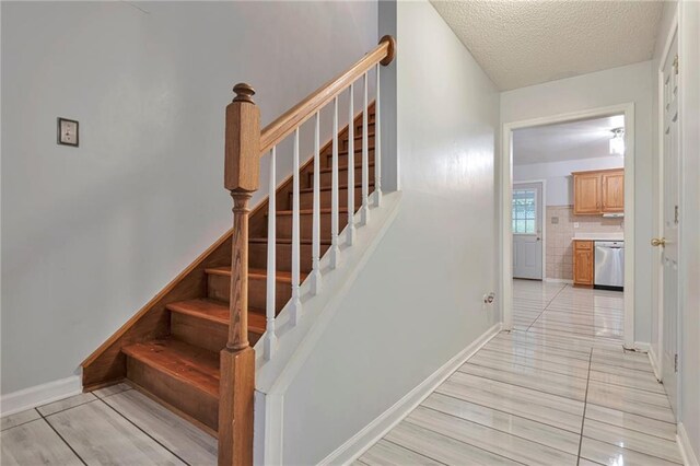 151 River Park Cir, Mcdonough, GA 30252 - stairway featuring baseboards and a textured ceiling
