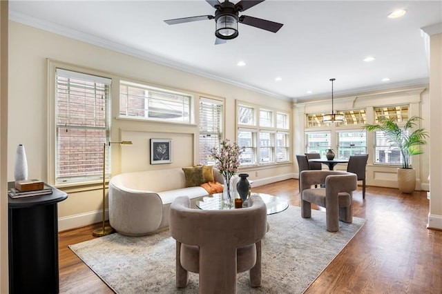 living area featuring crown molding, plenty of natural light, and dark hardwood / wood-style floors