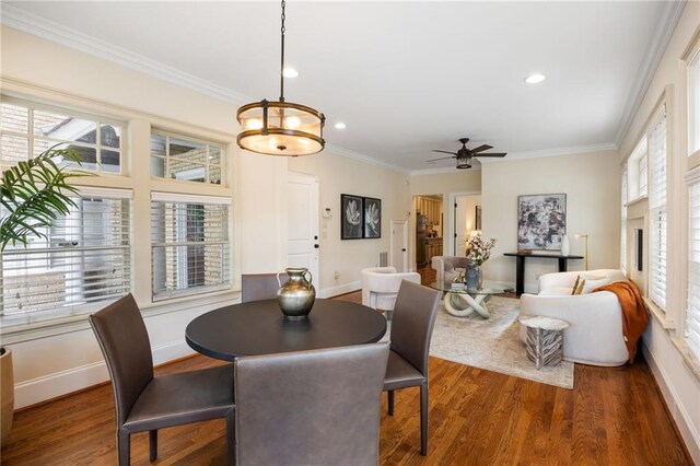 living room featuring wood-type flooring, ornamental molding, and a chandelier