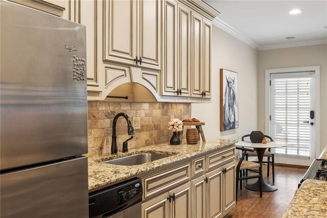 laundry room with wood-type flooring, crown molding, and stacked washer and clothes dryer