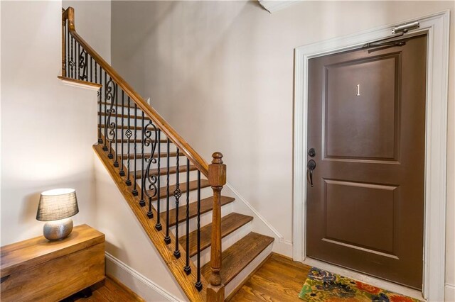 stairway with wood-type flooring