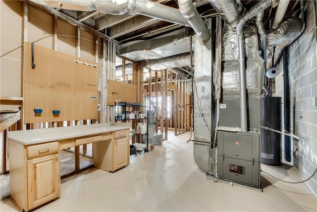 below grade area with gas water heater, a workshop area, and heating unit