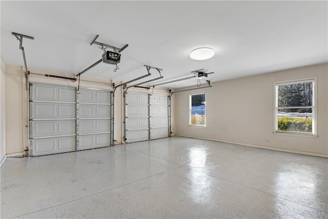 garage with baseboards and a garage door opener