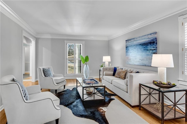 living area with baseboards, wood finished floors, and ornamental molding