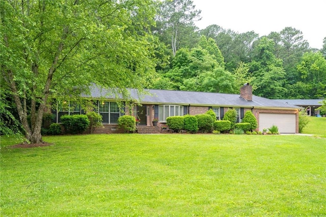 ranch-style home featuring a front lawn and a garage