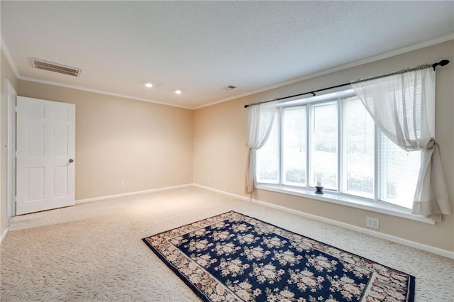 carpeted spare room with baseboards, visible vents, and ornamental molding