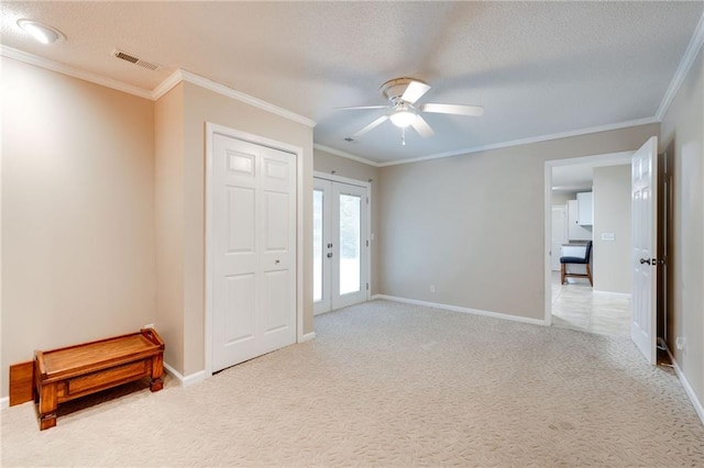 interior space featuring baseboards, french doors, visible vents, and light colored carpet