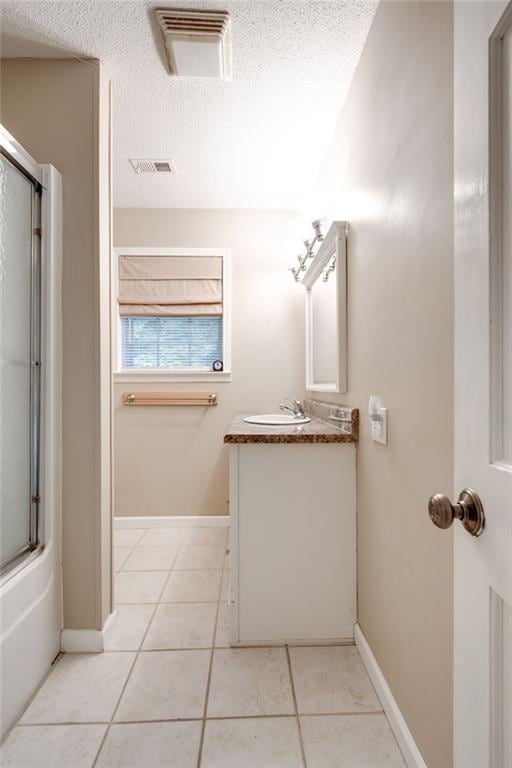 full bathroom featuring enclosed tub / shower combo, visible vents, vanity, and tile patterned floors