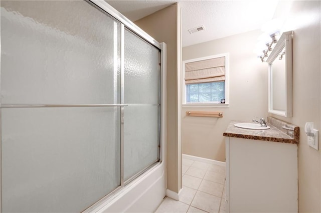 bathroom featuring baseboards, visible vents, enclosed tub / shower combo, tile patterned floors, and vanity