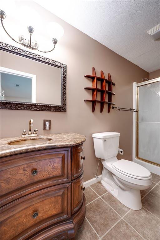 full bathroom featuring toilet, a shower with door, tile patterned flooring, a textured ceiling, and vanity