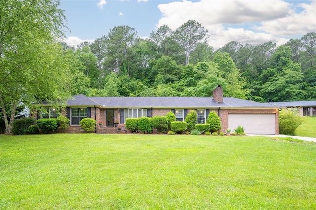 ranch-style home with brick siding, an attached garage, a chimney, and a front lawn