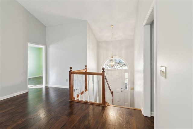 entrance foyer featuring an inviting chandelier and dark hardwood / wood-style floors