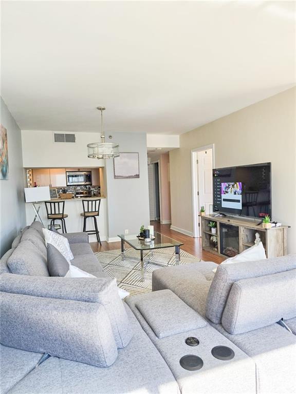 3481 Lakeside Dr NE Unit 2204, Atlanta, GA 30326 - living room with wood finished floors