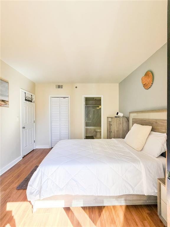 3481 Lakeside Dr NE Unit 2204, Atlanta, GA 30326 - bedroom with wood finished floors and ensuite bathroom