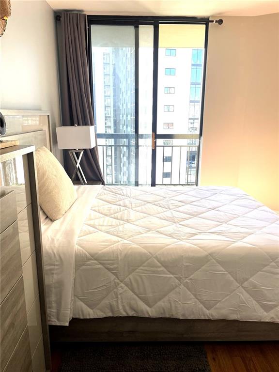 3481 Lakeside Dr NE Unit 2204, Atlanta, GA 30326 - bedroom with wood finished floors, floor to ceiling windows, and access to outside
