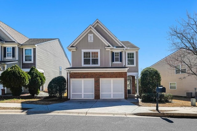 view of front of home featuring driveway, an attached garage, brick siding, central AC, and board and batten siding