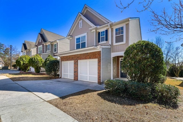 view of front of home featuring brick siding, driveway, a garage, and board and batten siding