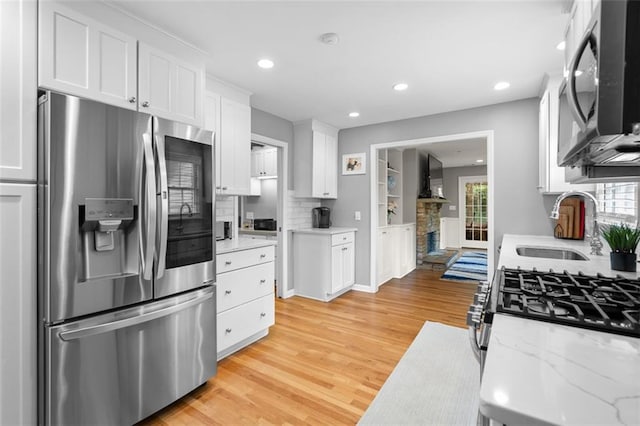 1959 Audubon Dr NE, Atlanta, GA 30329 - kitchen featuring stainless steel fridge, white cabinetry, light wood-style flooring, recessed lighting, and backsplash