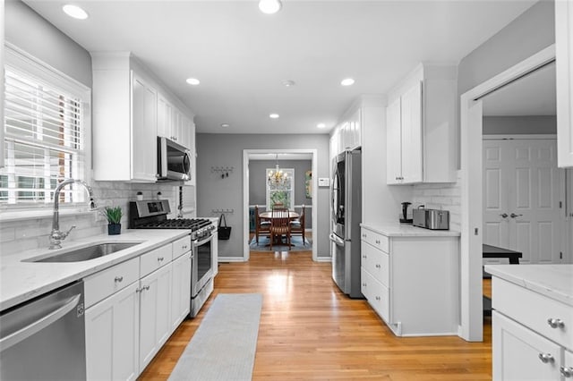 1959 Audubon Dr NE, Atlanta, GA 30329 - kitchen featuring stainless steel appliances, white cabinetry, decorative backsplash, light wood-style floors, and recessed lighting