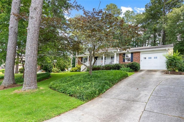 1959 Audubon Dr NE, Atlanta, GA 30329 - view of front of property featuring an attached garage, driveway, a front yard, brick siding, and covered porch