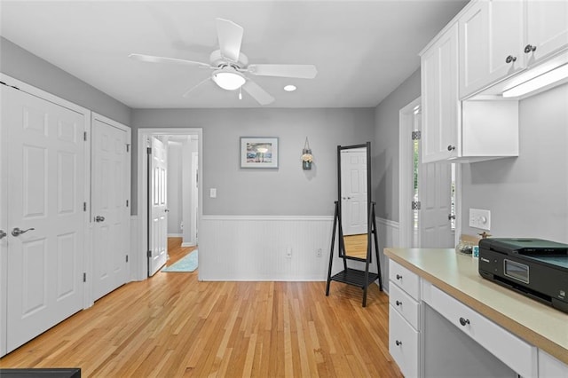 1959 Audubon Dr NE, Atlanta, GA 30329 - kitchen featuring light countertops, light wood-style floors, a wainscoted wall, white cabinetry, and ceiling fan