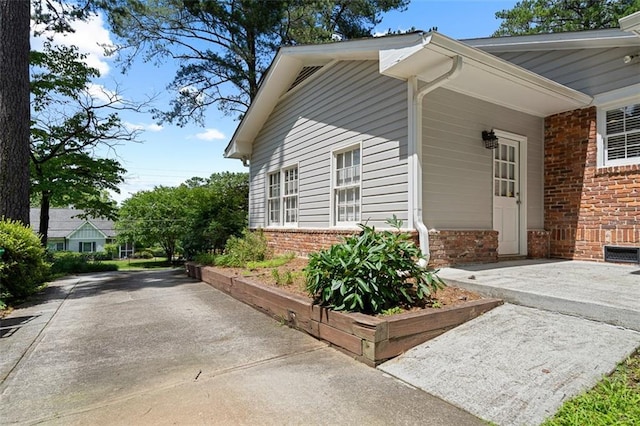 1959 Audubon Dr NE, Atlanta, GA 30329 - view of side of home with brick siding and concrete driveway