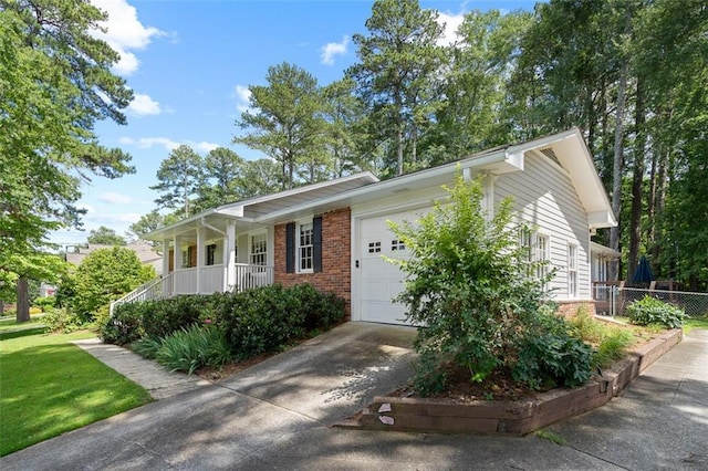 1959 Audubon Dr NE, Atlanta, GA 30329 - ranch-style house with brick siding, covered porch, a garage, and concrete driveway