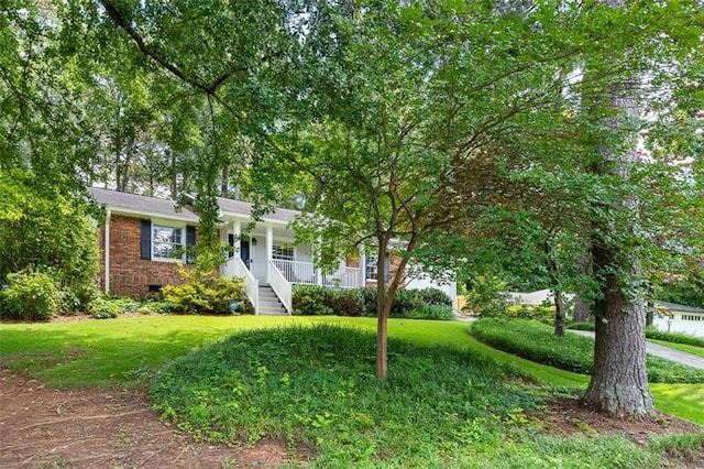 1959 Audubon Dr NE, Atlanta, GA 30329 - obstructed view of property with covered porch, a front lawn, stairs, and brick siding