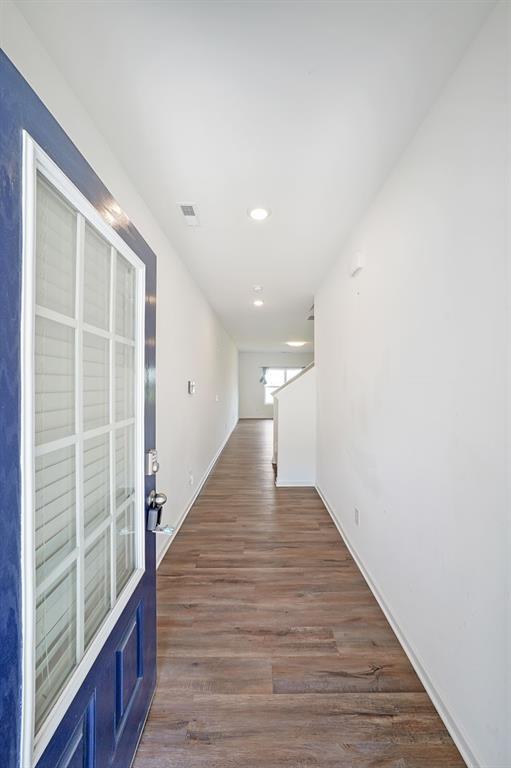 hallway featuring dark hardwood / wood-style flooring